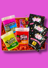 A box of three colourful jars of sensory putty with 3 packs of croc charm party bags on a purple background