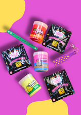 three jars of colourful sensory putty, three mystery packs of croc charms and two croc charm displays on a purple background 