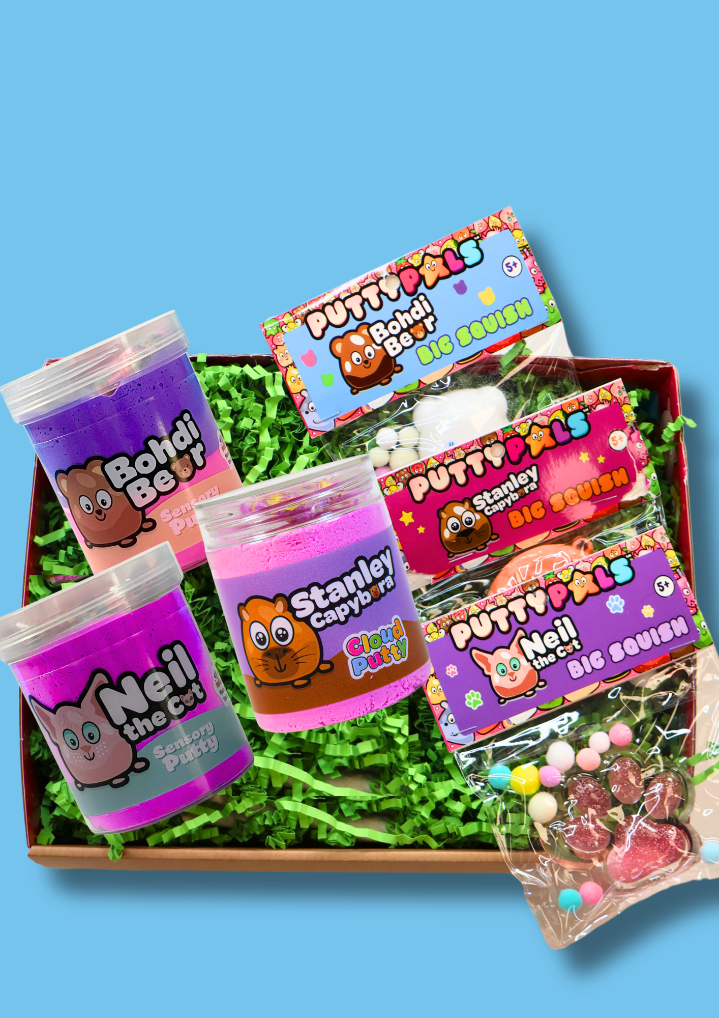 a box of 2 purple sensory putties and one jar of cloud putty with three taba squishies on a  blue background