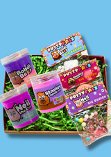 a box of 2 purple sensory putties and one jar of cloud putty with three taba squishies on a  blue background