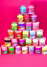 a tower of different coloured jars of cloud and sensory putty on a pink background