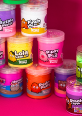 Close up of a tower of different coloured sensory putty jars that are in a tower, against a pink background
