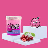 Duo pink sensory putty on a plinth, collectable charm Birdie Boba to the side, with some cherries showcasing the scent 