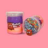 A jar of purple and pink sensory putty named Bohdi Bear. With a jar laid on its side showing bingsu beads, clay sprinkles and a bear charm