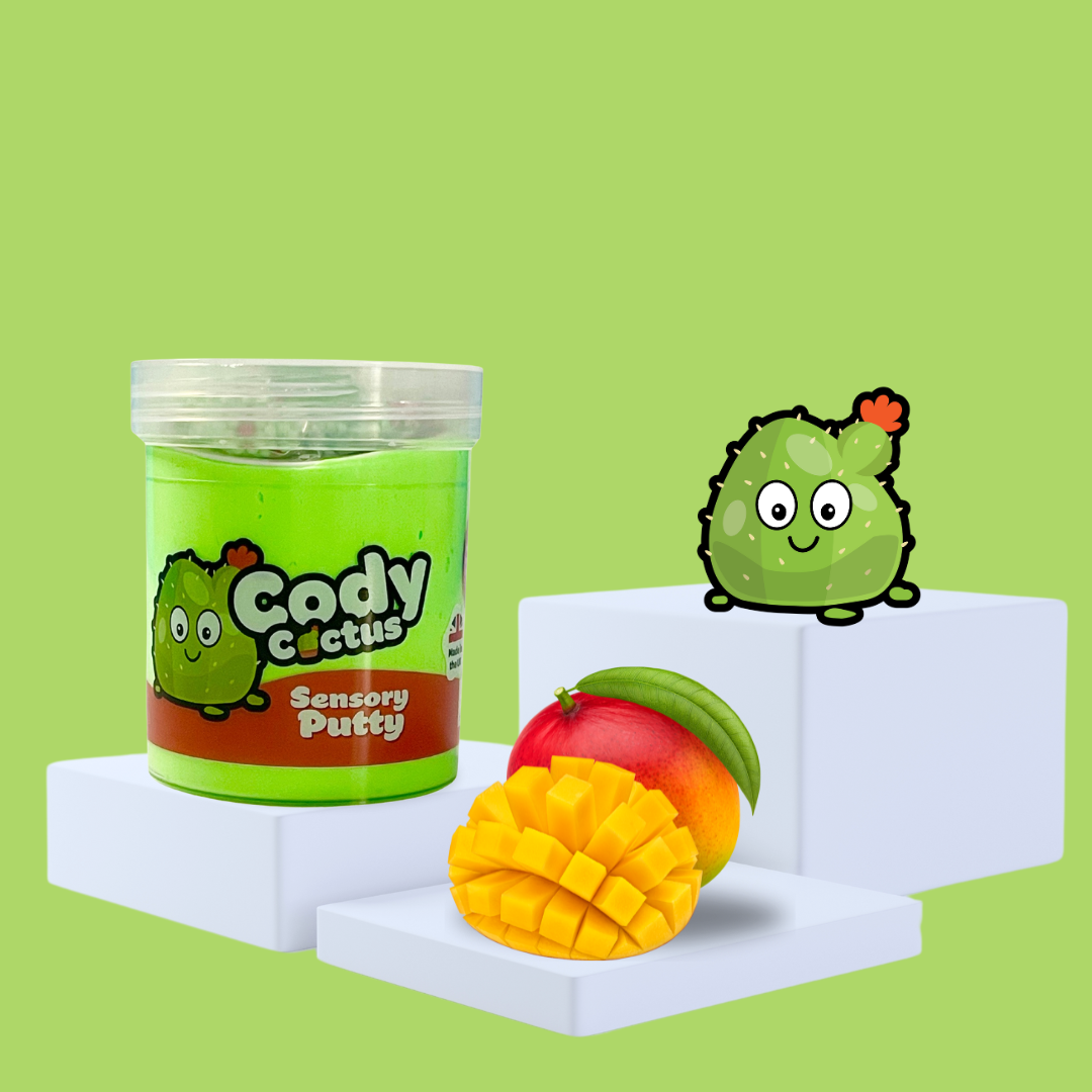 Green sensory putty on a plinth, collectable charm Cody Cactus to the side, with some mango showcasing the scent