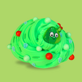 A bright green swirled sensory putty. Decorated with green and red floam balls. Green sprinkles and little cactus, a cartoon cactus with a smiling face charm is in the middle