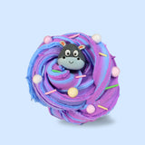 A blue and purple swirled sensory putty. Decorated with pastel floam beads and clay sprinkles. A cartoon hippo face charm is in the centre.