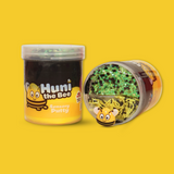 A jar of black and yellow sensory putty with a cartoon bee named Huni the Bee. Also a jar laid on its side showing the yellow and black bingsu beads,clay sprinkles and bee charm