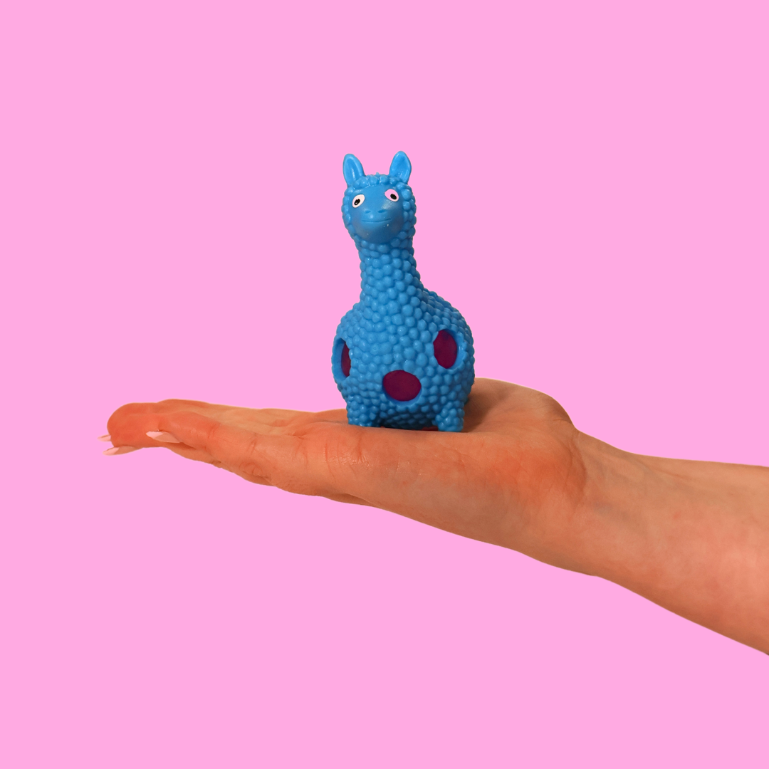 a blue orbs filled llama fidget toy in the palm of a hand, against a pink background