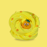 yellow swirled sensory putty decorated with small lemon slices, yellow sprinkles and white floam balls. A smiling cartoon lemon charm is in the middle