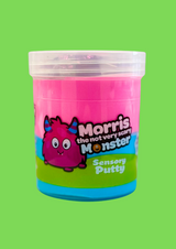 A jar of pink and blue sensory putty named Morris the not so scary Monster, with a cartoon monster on the front, against a green background