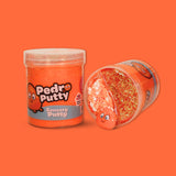 A jar of orange sensory putty called Pedro Putty, a jar laid on its side showing orange bingsu beads, clay sprinkles and an orange cartoon charm