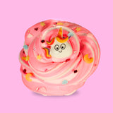 A pink and white swirled sensory putty decorated with iridescent binsu beads, clay sprinkles in the shapes of clouds, star and moons. In the middle is a larger cartoon unicorn charm