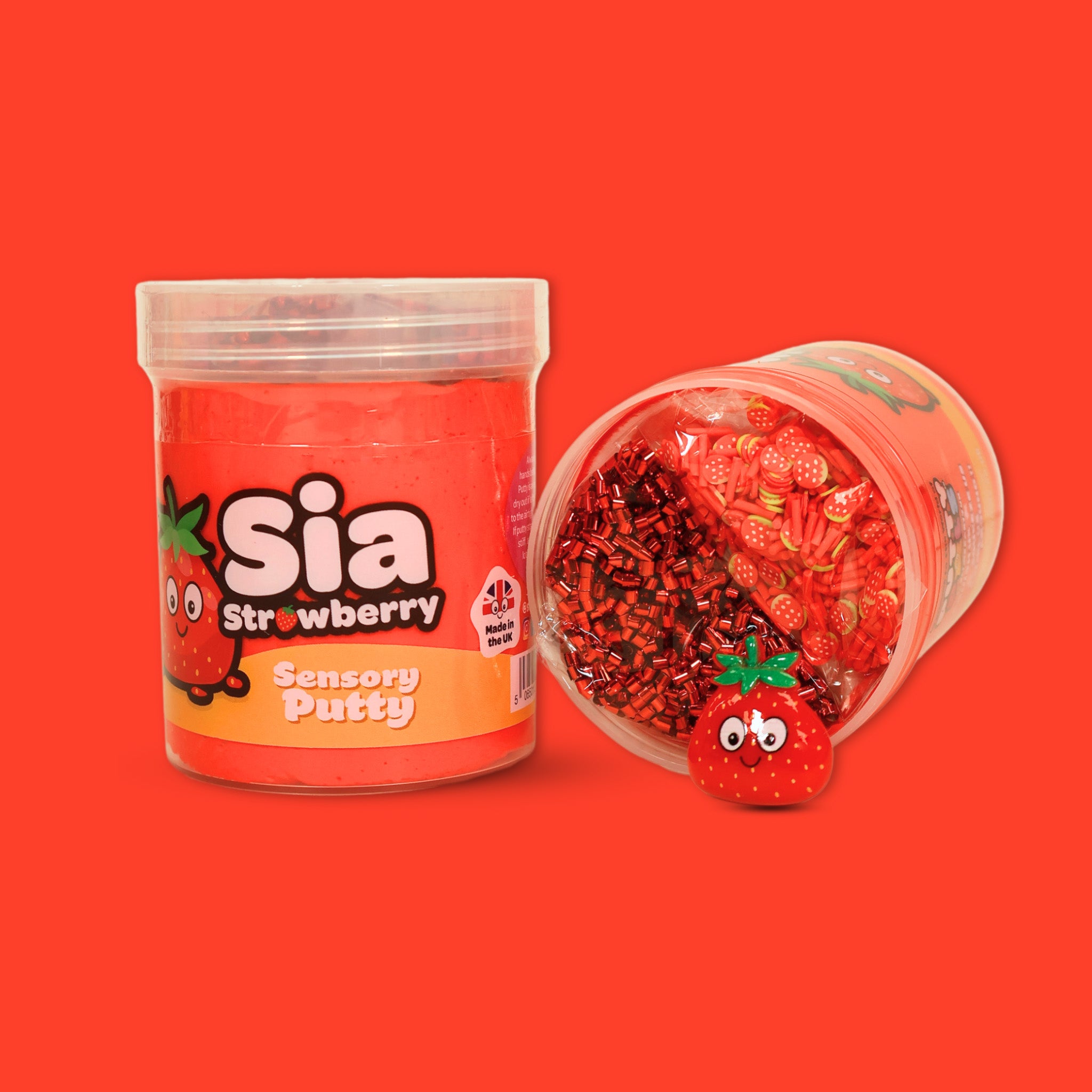 a jar of red sensory putty with Sia Strawberry on, next to a laid down jar showing red bingsu beads and clay sprinkles