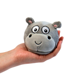 White background with a hand reaching in from the side holding a plush hippo sugar ball, with a smiley face